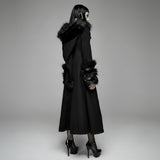 Black coat with fur trim on a gray background