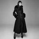 Black coat with fur trim worn by a model on a gray background
